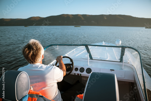mature man driving speedboat © tarasov_vl