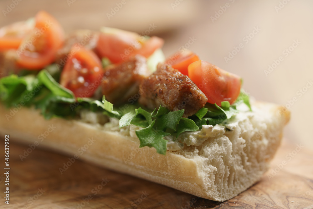 open sandwich with fried pork, salat and tomatoes on kitchen table, shallow focus open sandwich with fried pork, salat and tomatoes on kitchen table, shallow focus