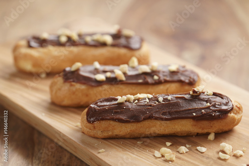 Fotomurale traditional french eclairs with chocolate and hazelnuts, shallow focus