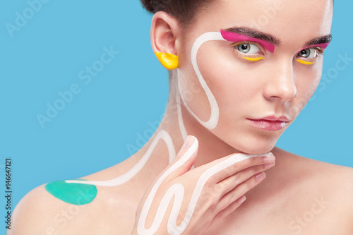 Obraz na plátně Portrait of the bright beautiful girl with art colorful painting make-up and bod