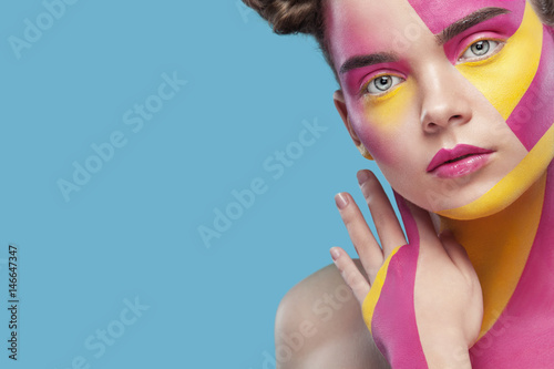 Obraz na plátně Portrait of the bright beautiful girl with art colorful painting make-up and bodyart