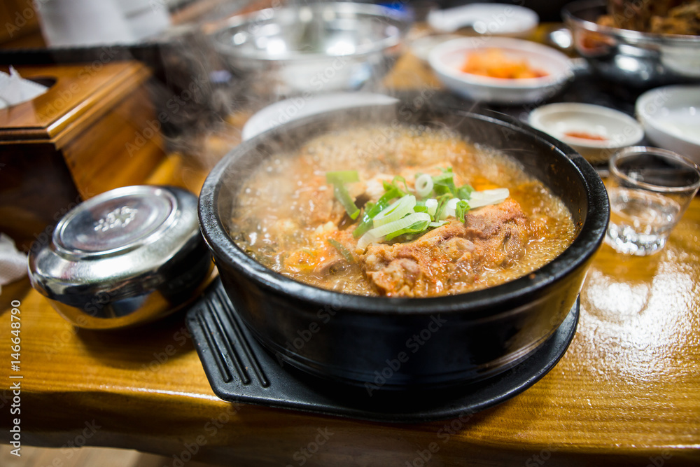 A bowl of soupin the korean restaurant.