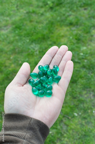 green tablets on palm