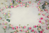Pink and white rose flowers frame with copy space on gray background, retro toned