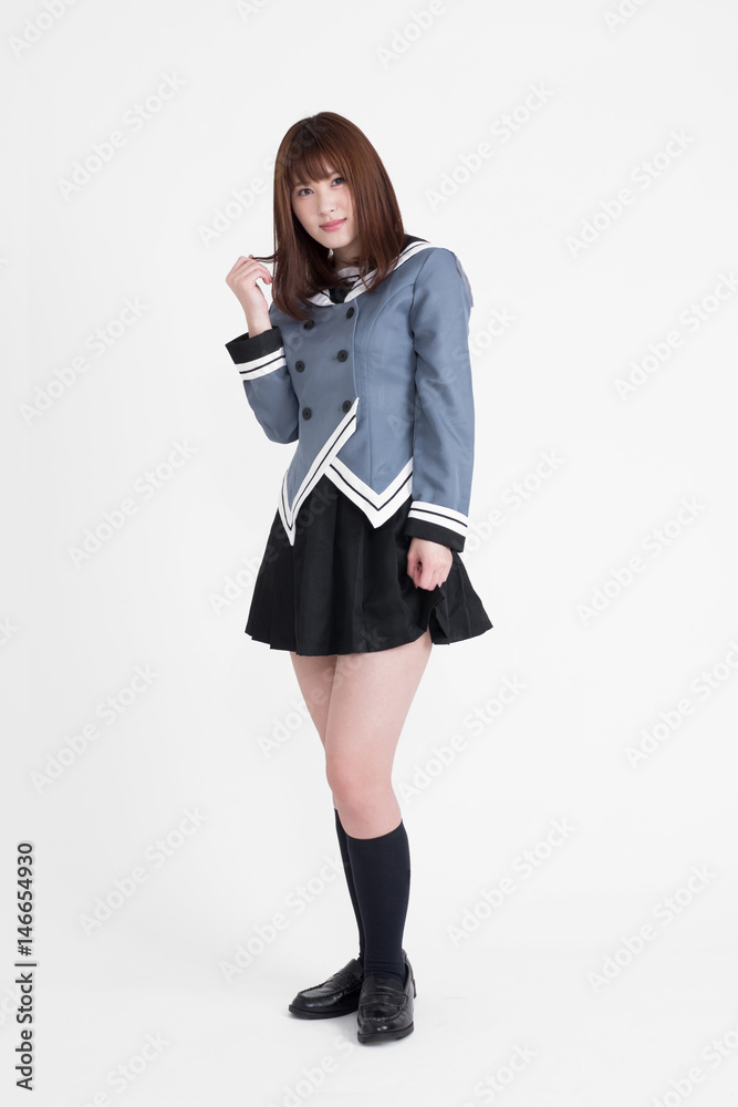 若い女性が、制服を着ています。この画像は、白背景です。女性がAKBのような衣装を着ています。 若い女性が、制服を着ています。この画像は、白背景です。女性がAKBのような衣装を着ています。