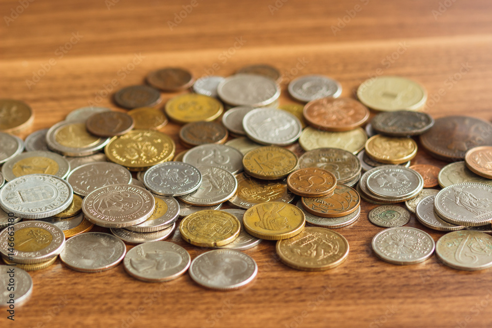 Different gold and silver collector's coins on the wooden table Different gold and silver collector's coins on the wooden table