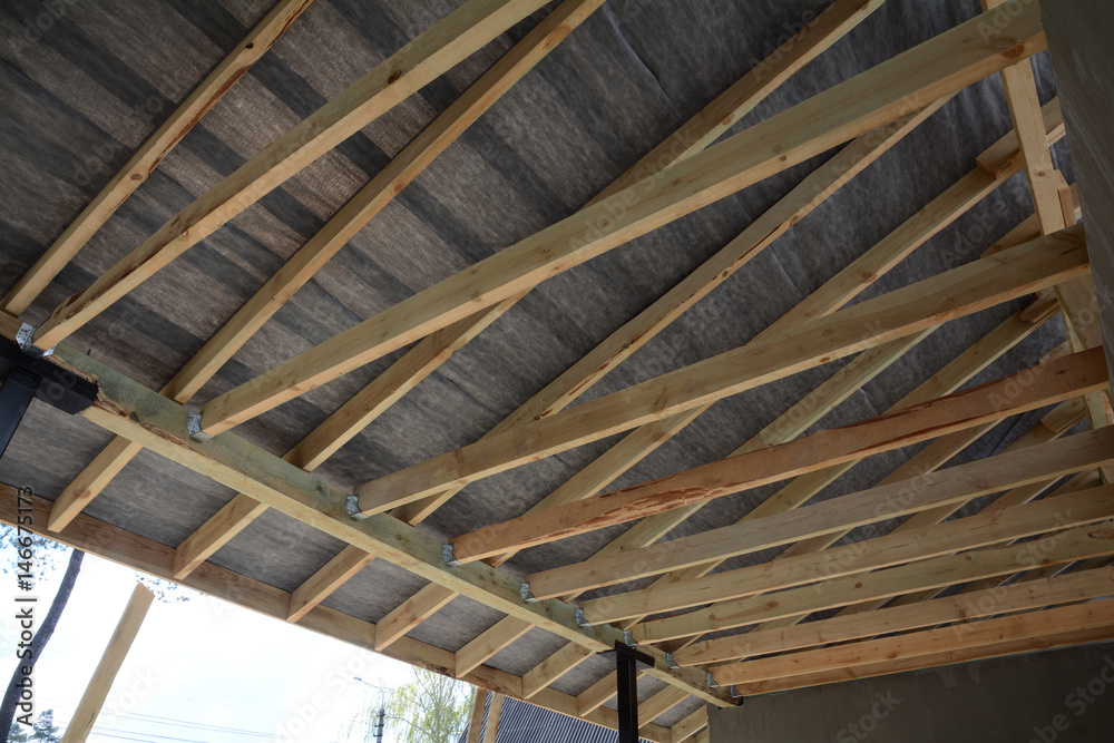 Roof contractor repair. Wooden roof construction. house building. Installation of wooden beams at construction the roof truss system of the house.
