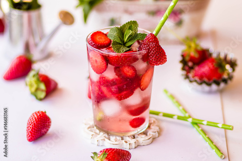 Homemade strawberry lemonade with mint on a white background
