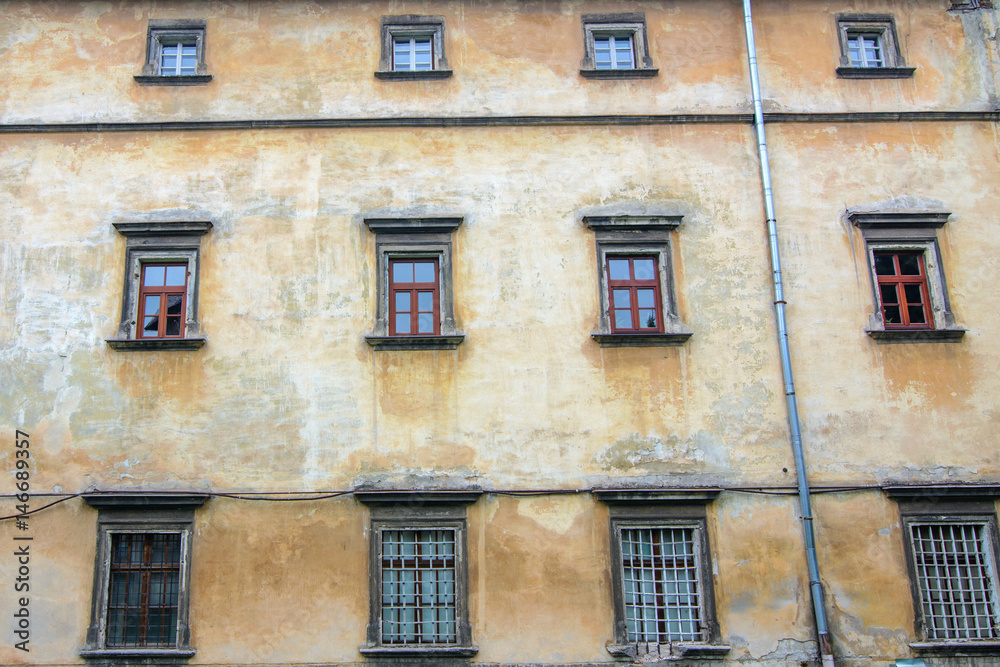 Fototapeta premium retro wooden windows on a cracked concrete vintage brick wall background 