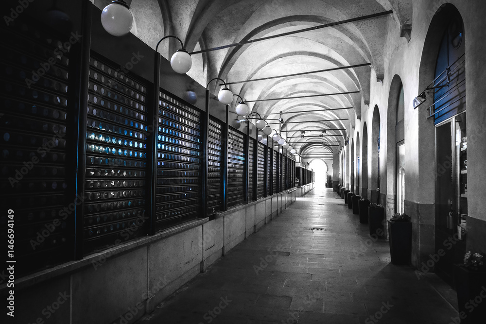 black and white arcade selective color blue light closed shops padova veneto italy