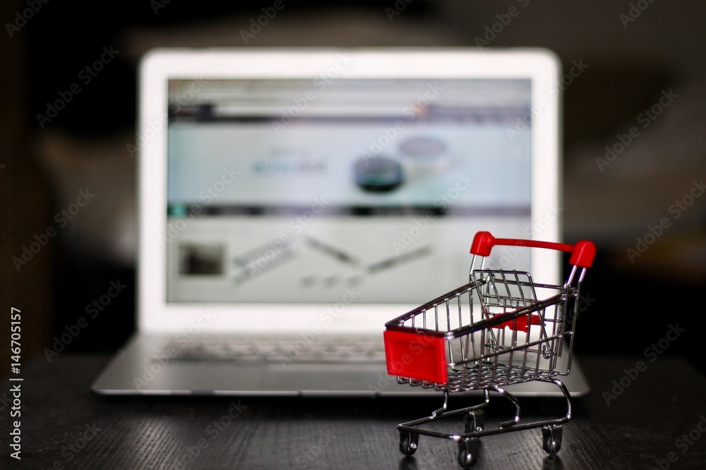 Red Shopping Cart in front of Laptop