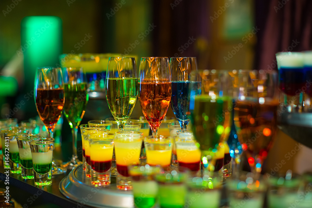 cocktail colorful background in night club on bar table top