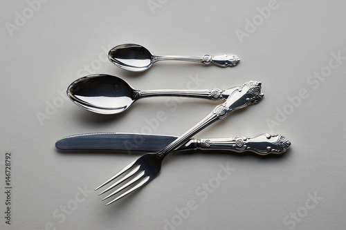 Cutlery. Set with fork, knife and spoons on gray background