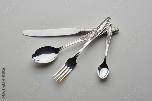 Cutlery. Set with fork, knife and spoons on gray background