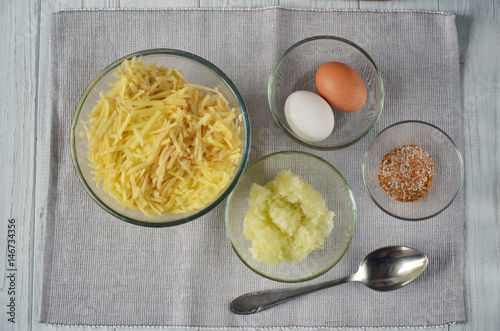 Ingredients and the process of making potato pancakes photo