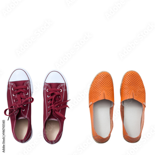 Flat lay fashion set: colored slippers shoes on white wooden background. Top view.
