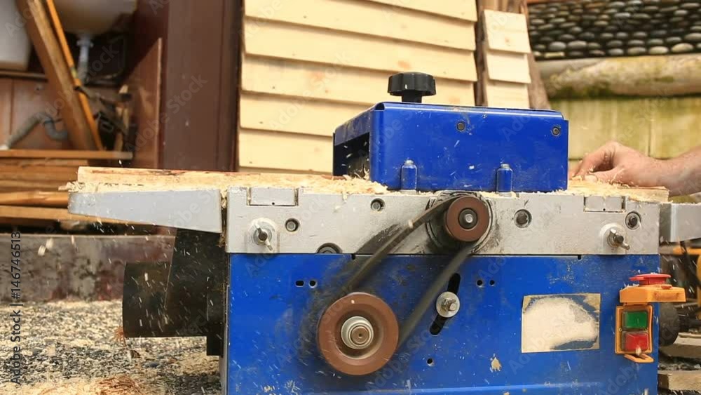The hands of man. Planing boards marking gauge machine.