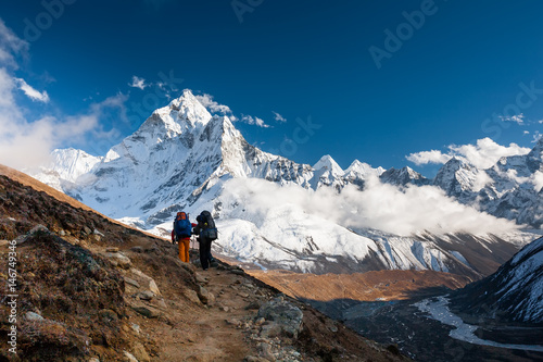 Trekkers approaching Amadablan mount in Khumbu valley on a way to Namche Bazar © Maygutyak