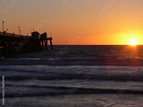 Ocean sunset with pier and waves 