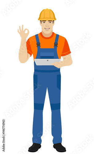 Builder holding digital tablet and showing a okay hand sign