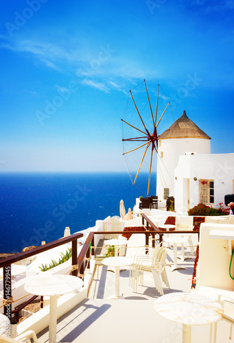 Windmill and blue Aegan sea at Oia, Santorini, Greecer, retro toned