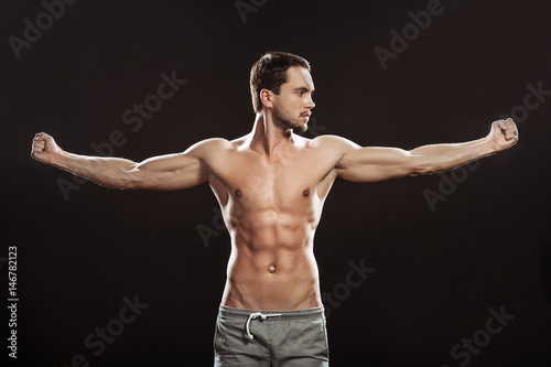 Young man athlet muscle body portrait in gym