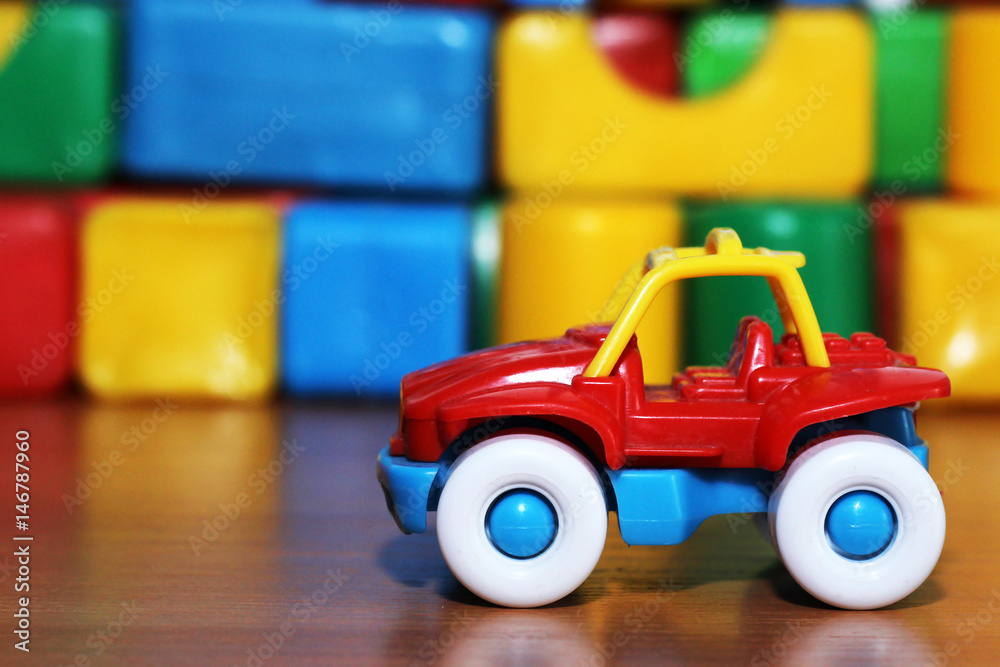 Car toy on the background of colored cubes Car toy on the background of colored cubes