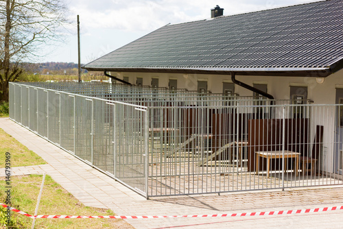 Outdoor dog kennels outside a building. photo