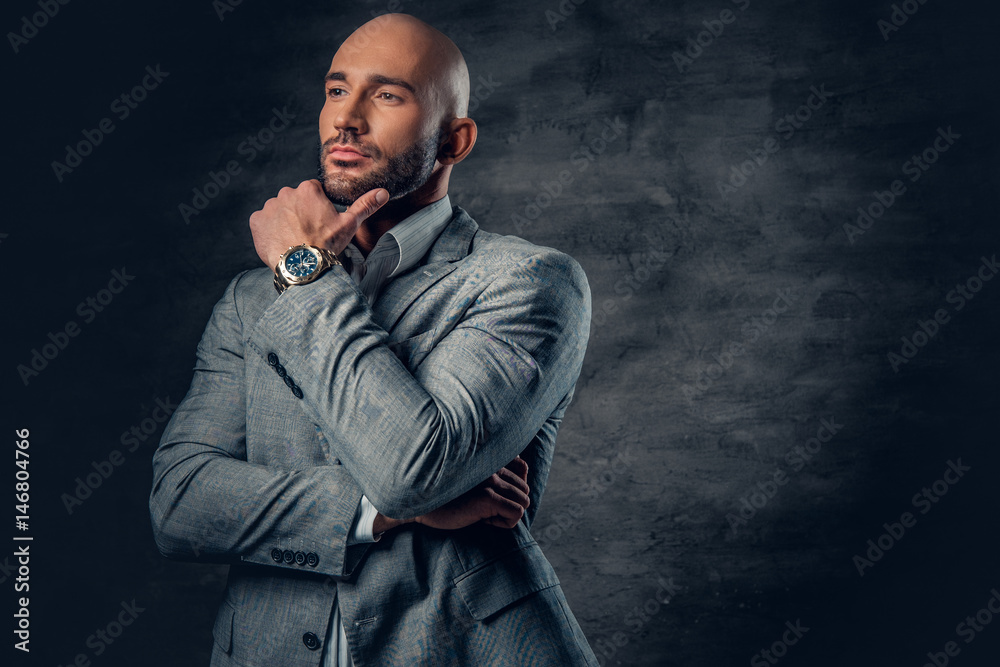 Positive shaved head male dressed in a grey suit. Positive shaved head male dressed in a grey suit.
