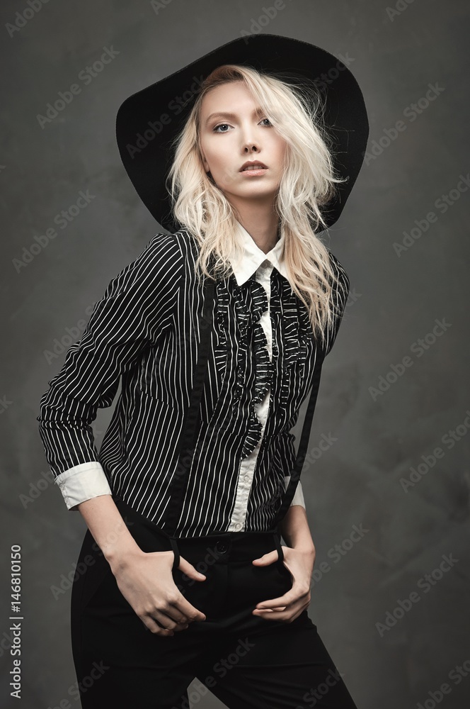 A tall girl dressed in black blouse with white stripes and black pants. A tall girl dressed in black blouse with white stripes and black pants.
