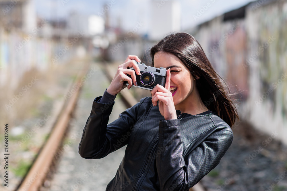 Attractive girl takes pictures with an old camera Attractive girl takes pictures with an old camera