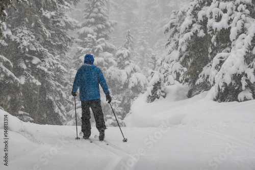 Man cross-country skiing in a snowstorm