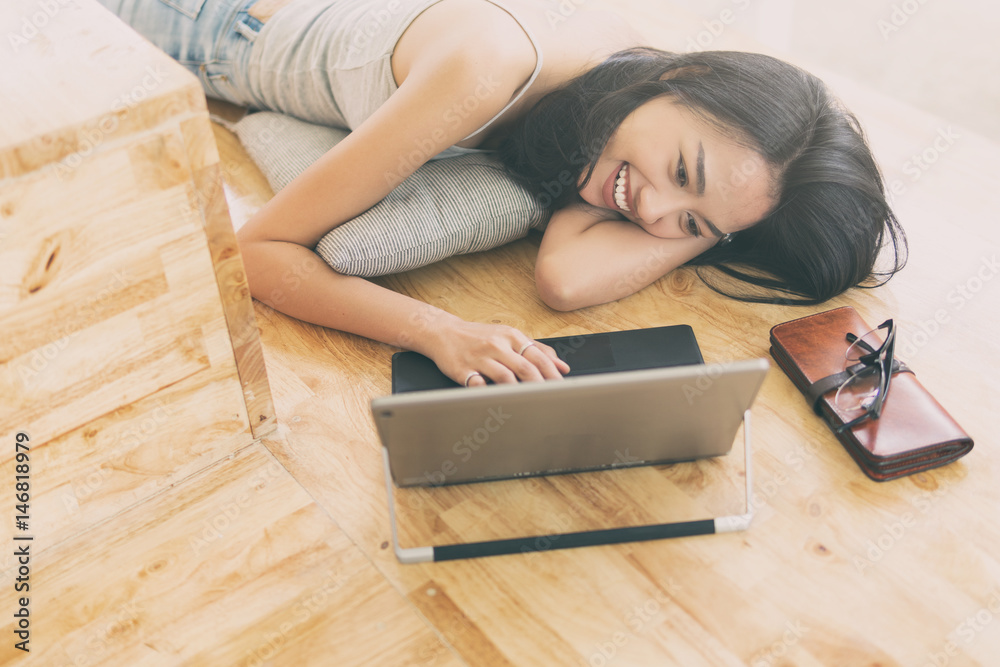 woman relaxing lifestyle with laptop computer,playing with laptop on the floor,day light flare color effect and selective focus woman relaxing lifestyle with laptop computer,playing with laptop on the floor,day light flare color effect and selective focus
