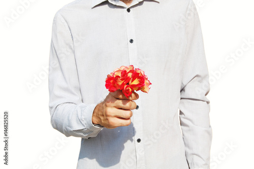 Man holding a small bouquet of roses in one hand