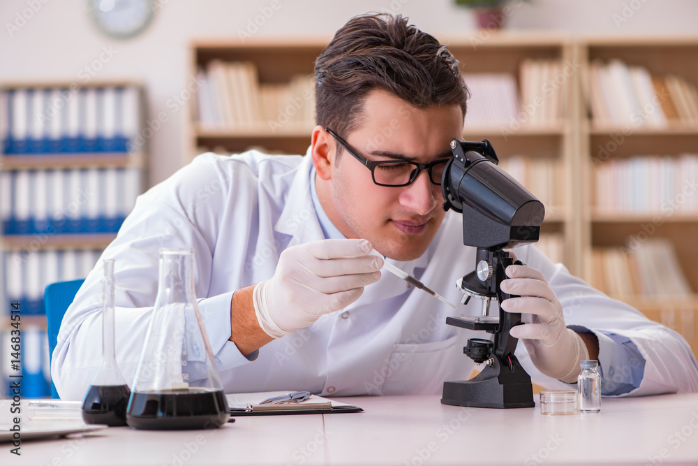 Young lab assistan working in the laboratory Young lab assistan working in the laboratory