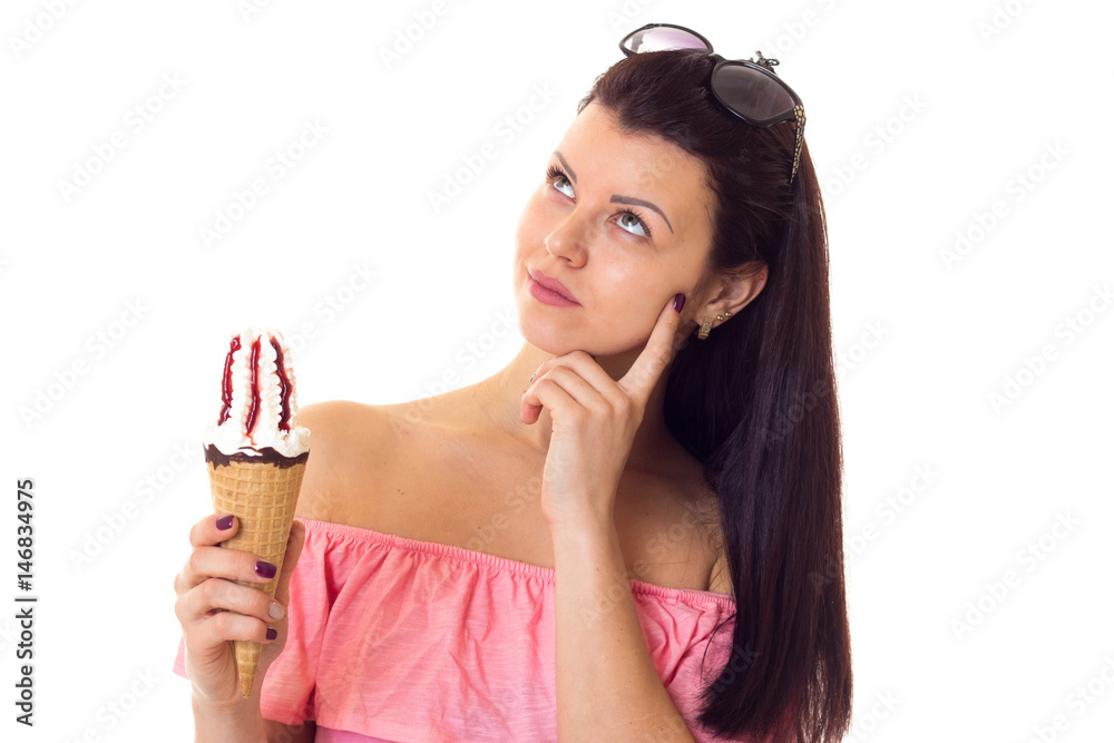Woman in dress with sunglasses holding ice-cream Woman in dress with sunglasses holding ice-cream