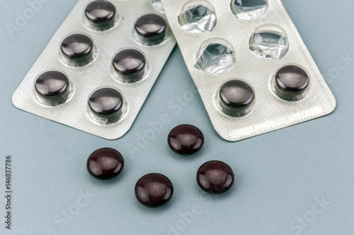 close up of medical pills isolated on blue background