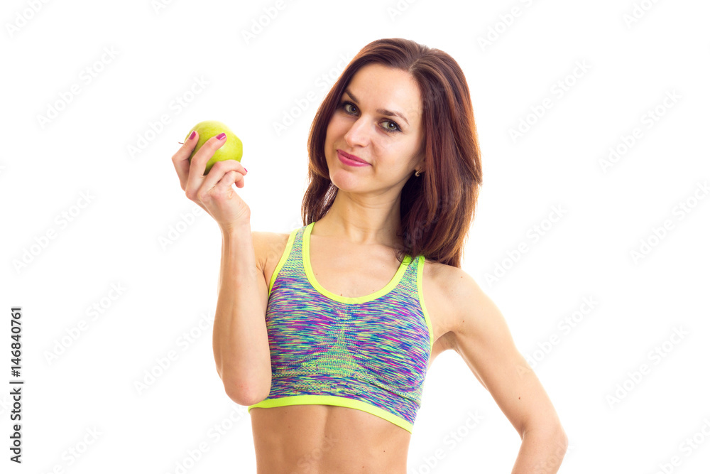 Sportive woman holding apple Sportive woman holding apple