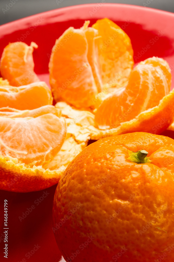 tangerines in a red plate