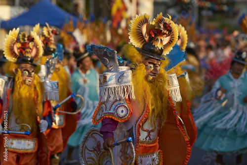 Masked Morenada dancers performing during a street parade at the annual Carnaval Andino con la Fuerza del Sol in Arica, Chile.