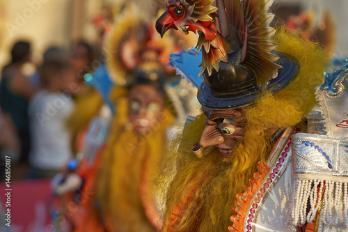 Masked Morenada dancers performing during a street parade at the annual Carnaval Andino con la Fuerza del Sol in Arica, Chile.