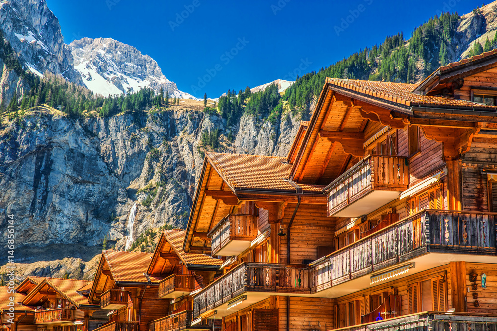 Colorful wooden houses with flowers in Kandersteg village, Canton Bern, Switzerland, Europe.