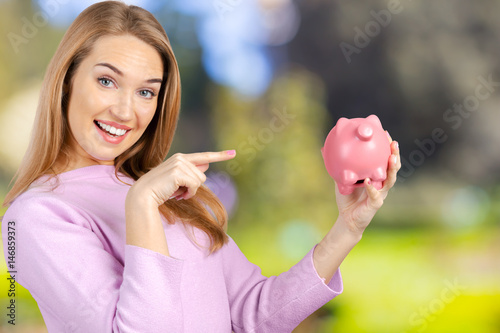 Care for Savings - Woman with a Piggy Bank