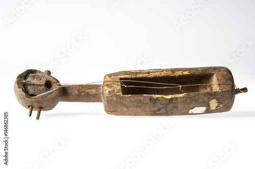 African music instrument with a face, made wooden, isolated on white background