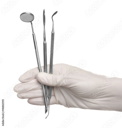 Hand holding dental equipment on white background
