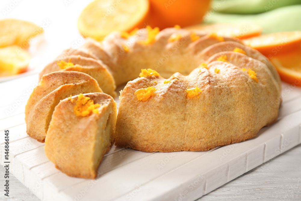 Sliced citrus cake on white wooden board Sliced citrus cake on white wooden board