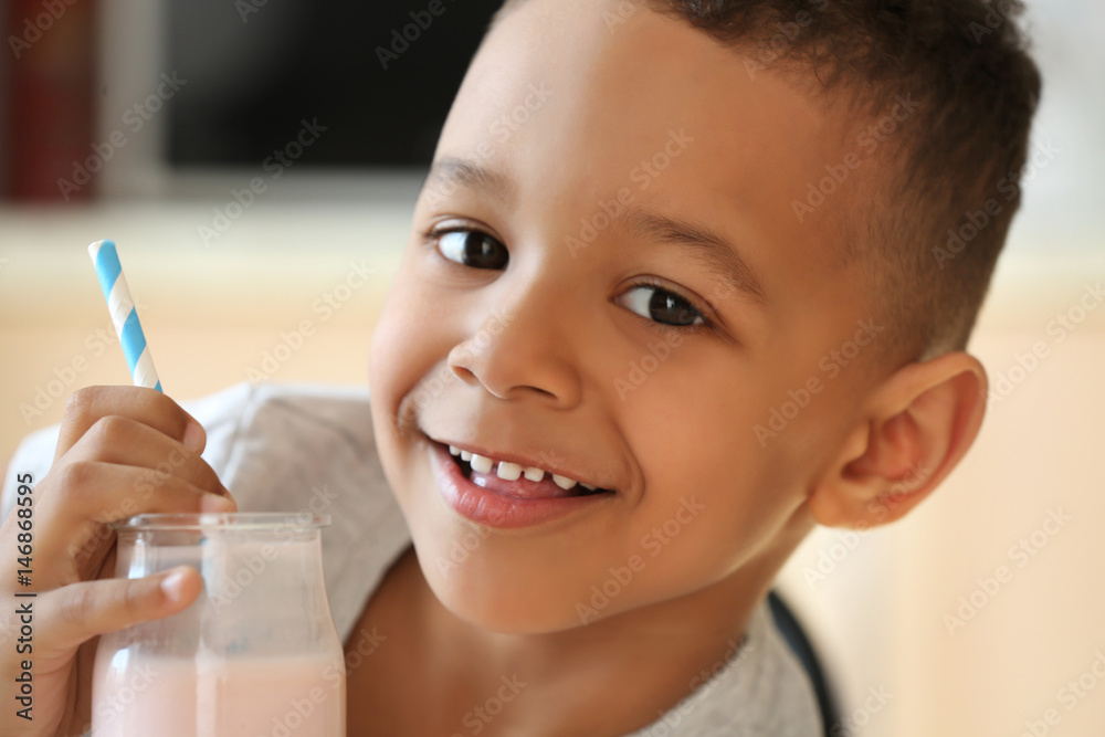 Cute African American boy drinking yogurt at home, closeup Cute African American boy drinking yogurt at home, closeup