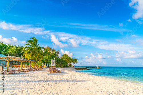 Fototapeta Naklejka Na Ścianę i Meble -  Beach chairs with umbrella at Maldives island, white sandy beach and sea .