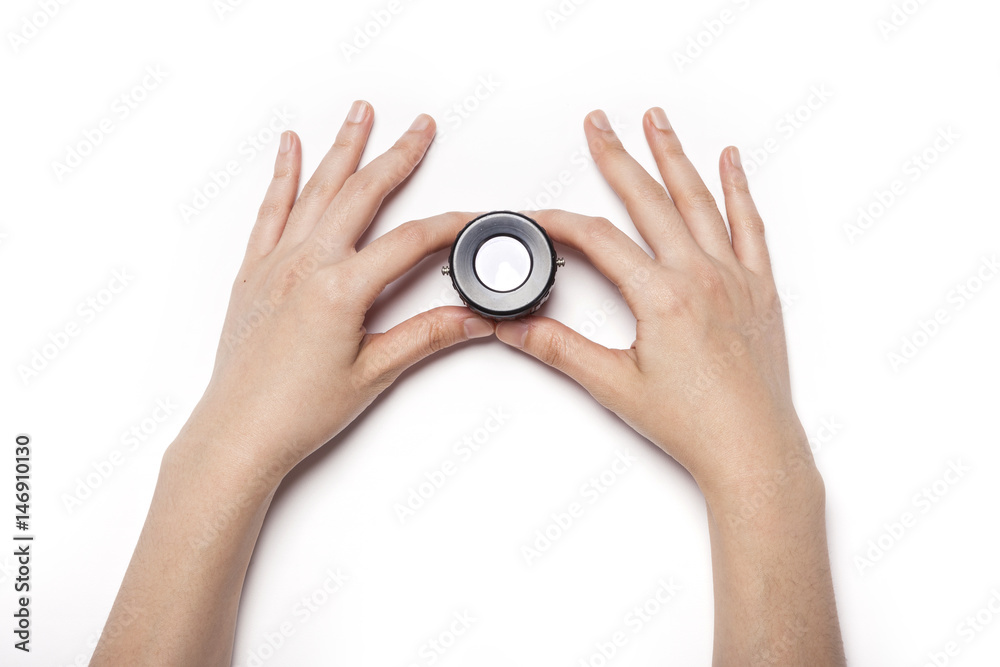 woman hand hold a photo lupe isolated white. woman hand hold a photo lupe isolated white.