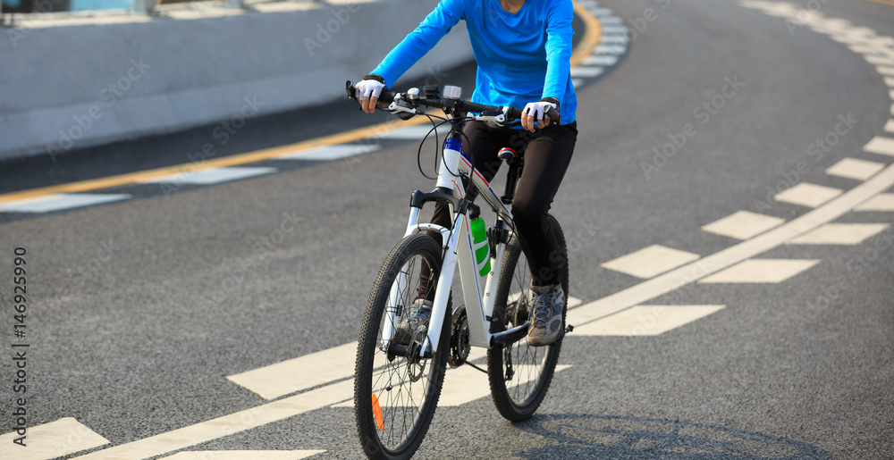 Fototapeta premium one woman cycling mountain bike on road